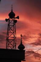 silhouette of the mosque dome against the twilight sky background photo