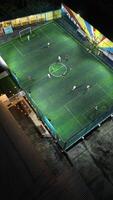 Aerial view of mini football match, soccer. MiniFootball field and Footballers from drone photo