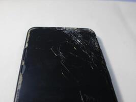 Black broken touch screen phone with cracked screen photo