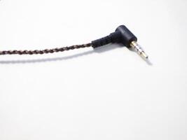 Black power cable with plug isolated on white background photo