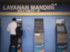 Jakarta, Indonesia on July 7 2022. Defocused photo or blurred photo of an airplane passenger who is self-checking in at the machine available at Halim Perdanakusuma Airport.