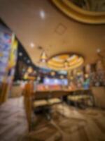 Jakarta, Indonesia on July 7 2022. Blurred defocus photo of the interior of a Chinese restaurant in a mall in Jakarta, dominated by yellow lights, giving the impression of luxury.