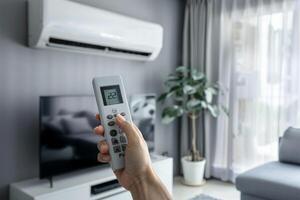 hand with remote control of air conditioner, photo