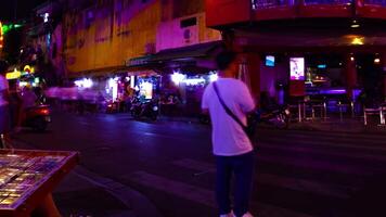 A night timelapse of the neon downtown at Bui Vien street in Ho Chi Minh Vietnam wide shot panning video