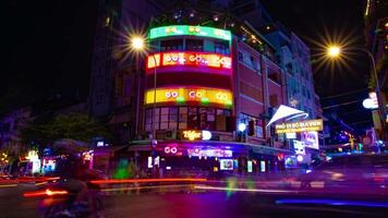 A night timelapse of the neon downtown at Bui Vien street in Ho Chi Minh Vietnam wide shot tilt video