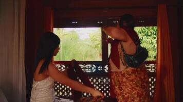 Two people enjoying a scenic train journey, looking out of a window with lush greenery in the background. video