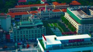 A timelapse of miniature traffic jam at Ho Chi Minh People's Committee Office Building high angle titlshift panning video