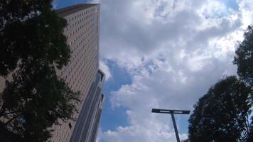 A moving cityscape of the buildings at the businesstown in Shinjuku Tokyo low angle video