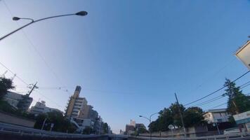 A moving cityscape at the downtown at Kanpachi avenue in Tokyo by low angle video