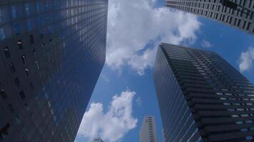 A moving cityscape of the buildings at the businesstown in Shinjuku Tokyo low angle video