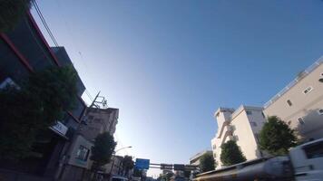 A moving cityscape at the downtown at Kanpachi avenue in Tokyo by low angle video