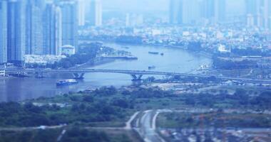 A high angle view of miniature cityscape at Saigon river in Ho Chi Minh tiltshift video