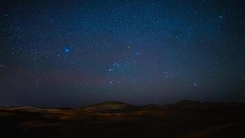 A timelapse of starry sky at Sahara desert in Morocco wide shot panning video