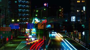 A timelapse of the street at the downtown in Tokyo at night long exposure middle shot tilt video