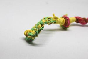 Rubber bands woven into a blowpipe, isolated white photo