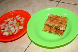 Egg martabak with sliced dish photo