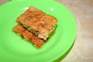 Egg martabak with sliced dish photo