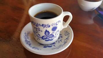 Blue white cup pot with black coffee wooden table Mexico. video
