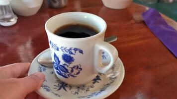 Blue white cup pot with black coffee wooden table Mexico. video