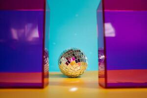 Mirror disco ball with pink geometric elements photo