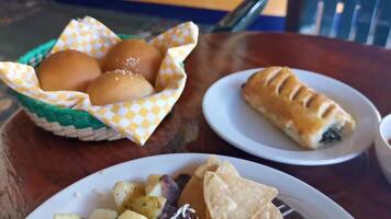 Mexican omelet eggs black beans potatoes nachos on white plate. video