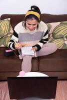 Woman greets her online community during crochet classes. photo