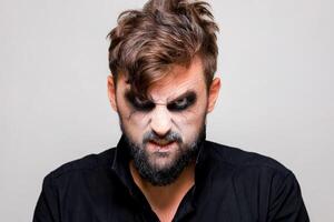 The frightening look of a bearded man with undead-style makeup for Halloween photo