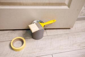 Prepare for coloring with a paintbrush and paint. Repair staining the doors with paint. photo