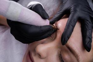 Permanent eyebrow makeup and eyebrow airbrushing. PMU Procedure, Permanent Eyebrow Makeup. photo