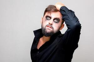 halloween and makeup for a bearded man who tears the hair on his head photo