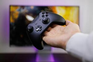 There's a game controller on the palm of your hand. game gamepad in hand photo