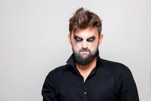 bearded men with makeup for Halloween looks at the camera photo