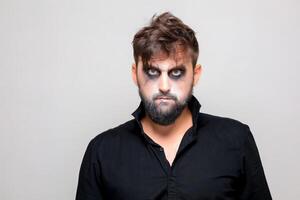 bearded men with makeup for Halloween looks at the camera photo