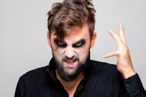 The frightening look of a bearded man with undead-style makeup for Halloween photo