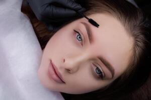 Result after permanent eyebrow makeup procedure in a beautiful girl. PMU Procedure, Permanent Eyebrow Makeup. photo