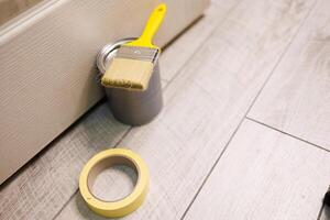 Prepare for coloring with a paintbrush and paint. Repair staining the doors with paint. photo
