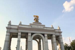 Main entrance to VDNH. Moscow Exhibition of Achievements. Main triumphal architecture arch of the central entrance of VDNKH. Moscow, Russia - September 20, 2023 photo