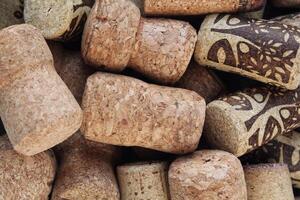 Pile of natural wooden wine corks close up as background. Concept of environmental protection and waste separation. Recycled closures used for sealing wine bottles photo