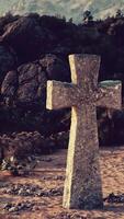 A cemetery cross standing tall amidst a breathtaking mountain range video