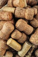 Pile of natural wooden wine corks close up as background. Concept of environmental protection and waste separation. Recycled closures used for sealing wine bottles photo