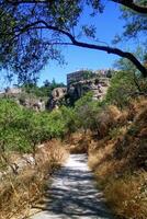 Trail to viewpoint of famous bridge Puente Nuevo in Ronda, Spain. Travel walking road on an alley. Footpath to the rock wall. Andalusian hiking route photo