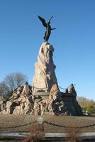 Bronze monument of mermaid with a cross on stone in Kadriorg park in Tallinn, Estonia. Sculpture of Rusalka to the Navy and the dead sailors photo