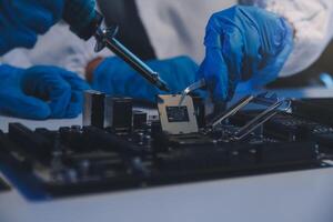 Close up of Technician measuring voltage electronic circuit board television, Service after sale fix electric equipment within insurance. photo