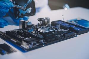 Close up of Technician measuring voltage electronic circuit board television, Service after sale fix electric equipment within insurance. photo