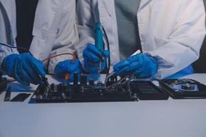 Close up of Technician measuring voltage electronic circuit board television, Service after sale fix electric equipment within insurance. photo