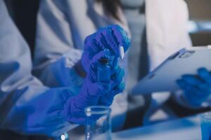 chemist,scientist hand dropping chemical liquid into test tube, science research and development concept photo