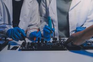 Close up of Technician measuring voltage electronic circuit board television, Service after sale fix electric equipment within insurance. photo