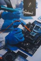 Close up of Technician measuring voltage electronic circuit board television, Service after sale fix electric equipment within insurance. photo