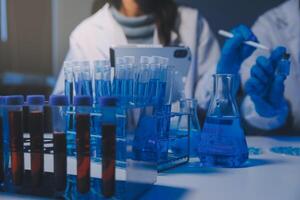 chemist,scientist hand dropping chemical liquid into test tube, science research and development concept photo