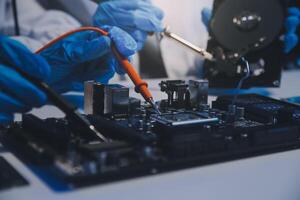 Close up of Technician measuring voltage electronic circuit board television, Service after sale fix electric equipment within insurance. photo